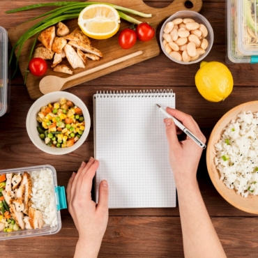 hands-writing-notebook-with-casseroles-ad-food_23-2148487771